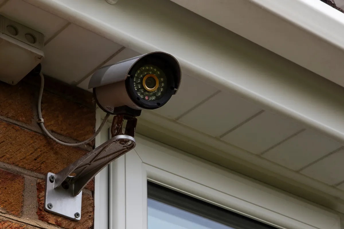 Technician carefully installing a security camera.